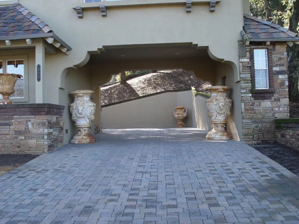 Luxurious stone paver driveway design in Morgan Hill, CA, showcasing timeless elegance and meticulous landscape construction for a refined residential entrance.